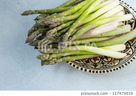 Asparagus sprouts on plate. Vegetable food. Asparagus sprouts on plate. Vegetable food. 117479839