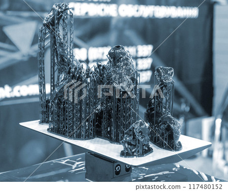 Black model with supports printed on 3D printer close-up. Part of object created on 3D printer from hardened rubber under influence of ultraviolet light. SLA 3D printing technology. Stereolithography Black model with supports printed on 3D printer close-up. Part of object created on 3D printer from hardened rubber under influence of ultraviolet light. SLA 3D printing technology. Stereolithography 117480152