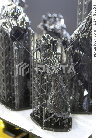 Model of hand printed on a 3D printer from black rubber, close-up. Part of an object created on a 3D printer from hardened rubber under the influence of ultraviolet light. SLA 3D printing technology. Model of hand printed on a 3D printer from black rubber, close-up. Part of an object created on a 3D printer from hardened rubber under the influence of ultraviolet light. SLA 3D printing technology. 117480153