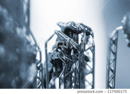 Model of hand printed on a 3D printer from black rubber, close-up. Part of an object created on a 3D printer from hardened rubber under the influence of ultraviolet light. SLA 3D printing technology. 117480175