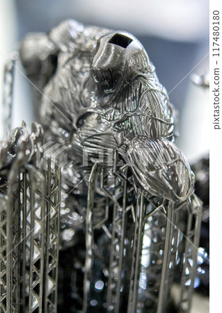 Black model with supports printed on 3D printer close-up. Part of object created on 3D printer from hardened rubber under influence of ultraviolet light. SLA 3D printing technology. Stereolithography Black model with supports printed on 3D printer close-up. Part of object created on 3D printer from hardened rubber under influence of ultraviolet light. SLA 3D printing technology. Stereolithography 117480180
