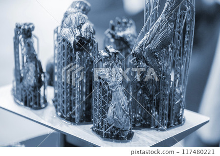 Black model with supports printed on 3D printer close-up. Part of object created on 3D printer from hardened rubber under influence of ultraviolet light. SLA 3D printing technology. Stereolithography 117480221