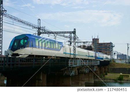 The Kintetsu Limited Express Shimakaze runs against the backdrop of summer cumulonimbus clouds. The Kintetsu Limited Express Shimakaze runs against the backdrop of summer cumulonimbus clouds. 117480451