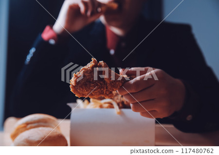 close up focus woman hand hold fried chicken for eat,girl with fast food concept close up focus woman hand hold fried chicken for eat,girl with fast food concept 117480762