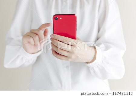 Woman holding a smartphone Woman holding a smartphone 117481113