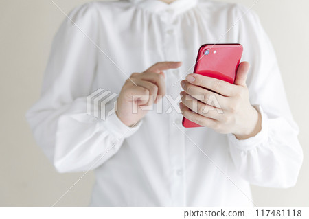 Woman holding a smartphone Woman holding a smartphone 117481118