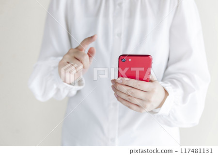 Woman holding a smartphone Woman holding a smartphone 117481131