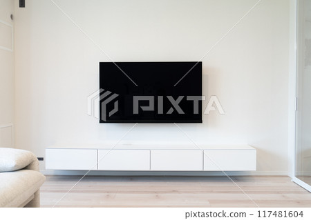 Living room sofa, floating TV stand, and wall-mounted TV before and after installation 117481604