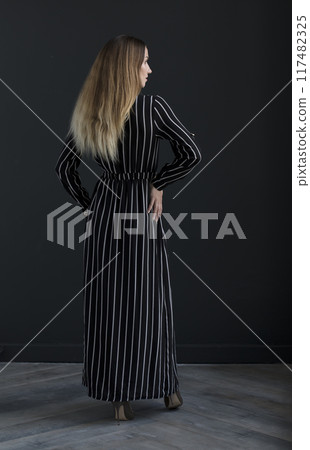 young beautiful woman on a dark background, full length studio shot young beautiful woman on a dark background, full length studio shot 117482325