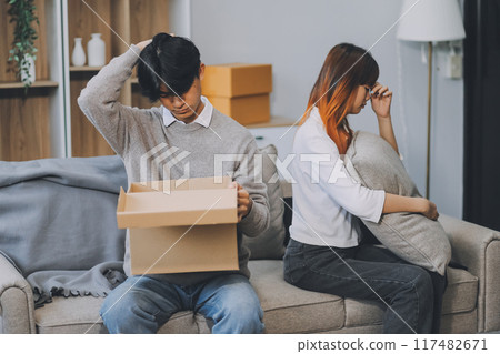 Offended couple ignoring each other after quarrel indoors, selective focus. Relationship problems 117482671