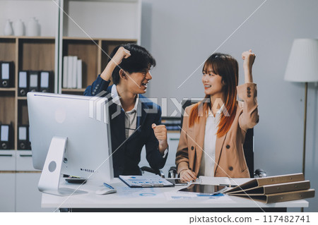Entrepreneur Asian businessman and businesswoman discussing new business project in tablet in modern Meeting In Modern Office, Asian business casual concept. 117482741