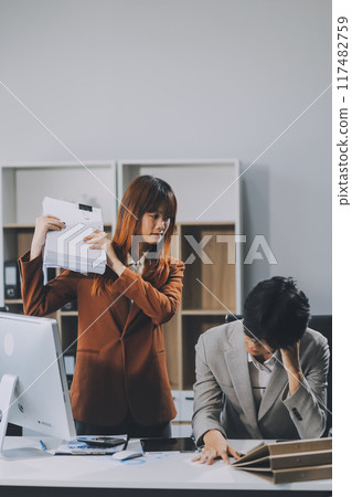 Stressed business couple working at big cabinet. Frustrated director closed face with hands at laptop workplace interior. Woman partner solving problems on smartphone call feeling nervous at office 117482759