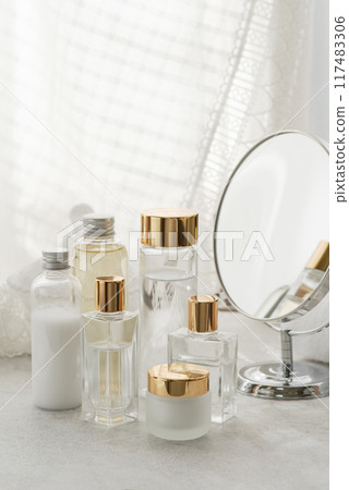 Cosmetic bottles, mirror and lace curtains Cosmetic bottles, mirror and lace curtains 117483306