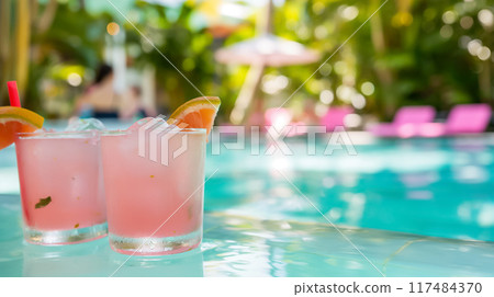 Enjoying refreshing poolside cocktails in a breathtaking tropical paradise, perfect for relaxation and indulgence on sunny days 117484370