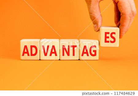 Advantages symbol. Concept word Advantages on beautiful wooden blocks. Beautiful orange background. Businessman hand. Business advantages concept. Copy space. 117484629