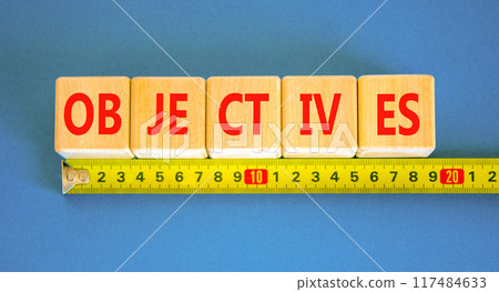 Objectives symbol. Concept word Objectives on beautiful wooden blocks. Beautiful blue background. Beautiful yellow ruler. Business objectives concept. Copy space. Objectives symbol. Concept word Objectives on beautiful wooden blocks. Beautiful blue background. Beautiful yellow ruler. Business objectives concept. Copy space. 117484633