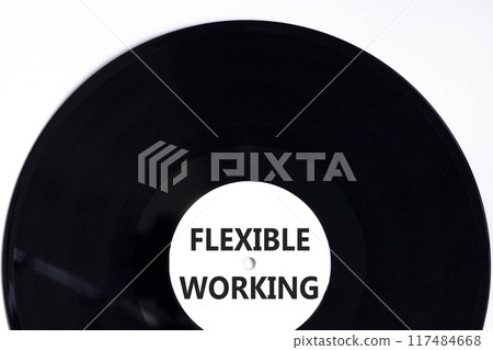 Flexible working symbol. Concept words Flexible working on beautiful white black vinyl disk. Beautiful white paper background. Business flexible working concept. Copy space. Flexible working symbol. Concept words Flexible working on beautiful white black vinyl disk. Beautiful white paper background. Business flexible working concept. Copy space. 117484668