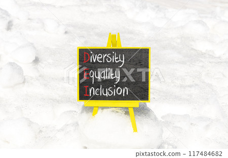 DEI diversity equality inclusion symbol. Concept words DEI diversity equality inclusion on yellow blackboard. Beautiful snow background. Business DEI diversity equality inclusion concept. Copy space. 117484682