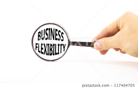 Business flexibility symbol. Concept words Business flexibility in beautiful magnifying glass. Beautiful white paper background. Businessman hand. Business flexibility concept. Copy space. 117484705