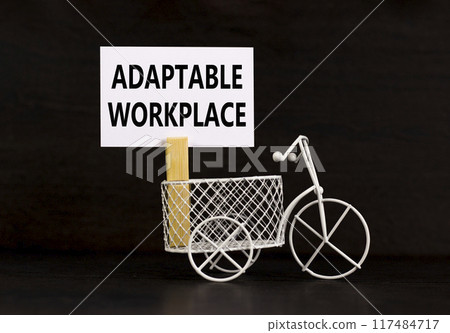 Adaptable workplace symbol. Concept words Adaptable workplace on beautiful white paper on wooden clothespin. Beautiful black background. Bike model. Business Adaptable workplace concept. Copy space. 117484717