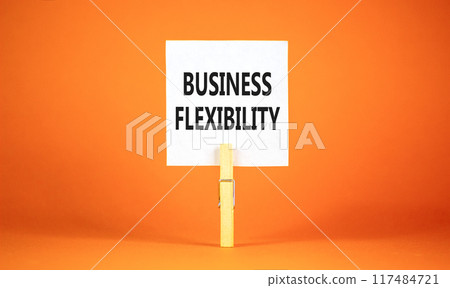 Business flexibility symbol. Concept words Business flexibility on beautiful white paper on wooden clothespin. Beautiful orange background. Business flexibility concept. Copy space. Business flexibility symbol. Concept words Business flexibility on beautiful white paper on wooden clothespin. Beautiful orange background. Business flexibility concept. Copy space. 117484721
