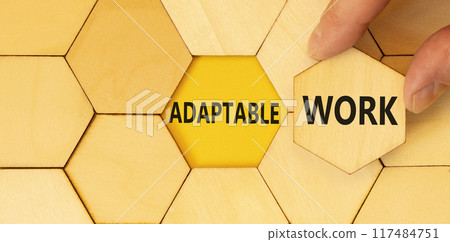 Adaptable work symbol. Concept words Adaptable work on beautiful wooden puzzles. Beautiful yellow background. Businessman hand. Business Adaptable work concept. Copy space. 117484751