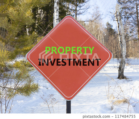 Property investment symbol. Concept words Property investment on beautiful red road sign. Beautiful forest trees snow background. Business Property investment concept. Copy space. Property investment symbol. Concept words Property investment on beautiful red road sign. Beautiful forest trees snow background. Business Property investment concept. Copy space. 117484755