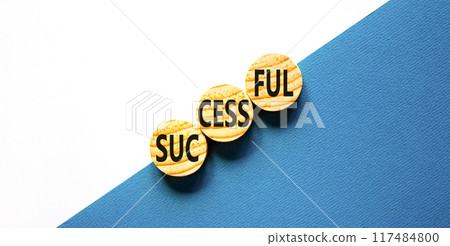 Successful symbol. Concept word Successful on beautiful wooden circles. Beautiful blue white background. Business successful concept. Copy space. 117484800