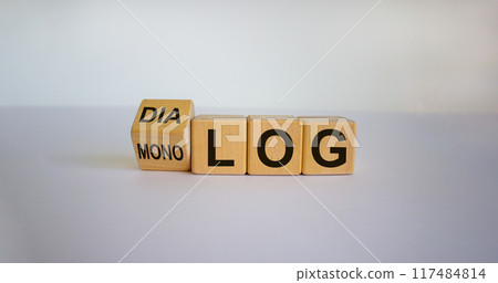 Fliped a cube and changed the German word 'monolog' - 'monologue' in English to 'dialog' - 'dialogue' in English. Beautiful white background. Business concept. Copy space. 117484814