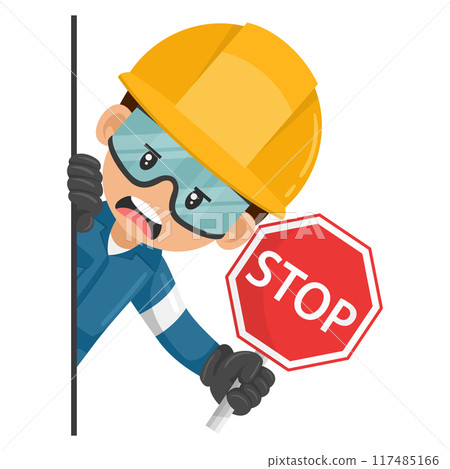 Annoyed industrial mechanical worker peeking out from behind a wall holding stop sign. Construction worker with his personal protective equipment. Industrial safety and occupational health at work 117485166