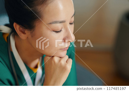 Reflecting Nurse Deep in Thought in Hospital Environment Reflecting Nurse Deep in Thought in Hospital Environment 117485197
