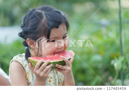 Child eating watermelon during summer vacation 117485459