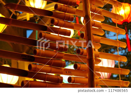 Asian lantern and bamboo folk instrument (torun) 117486565