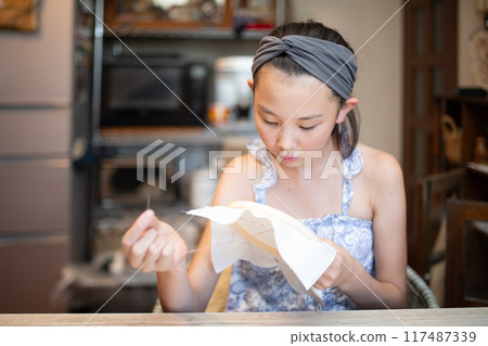 Girl doing embroidery Girl doing embroidery 117487339