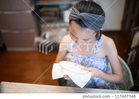 Girl doing embroidery Girl doing embroidery 117487340