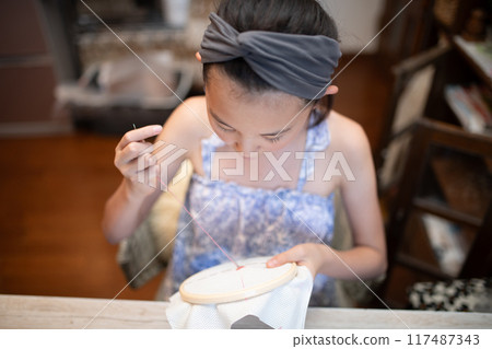 Girl doing embroidery 117487343