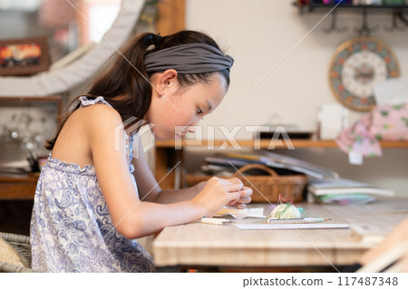 Girl doing embroidery Girl doing embroidery 117487348
