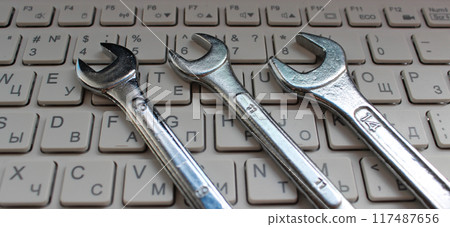 Computer Repairing Illustration. Hex Head Spanners On White Keys Of Laptop Keyboard Computer Repairing Illustration. Hex Head Spanners On White Keys Of Laptop Keyboard 117487656