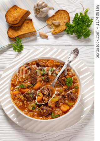 beef barley soup in a bowl, top view beef barley soup in a bowl, top view 117488168