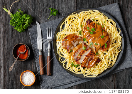 Chicken Lazone with sauce and linguine on plate 117488170
