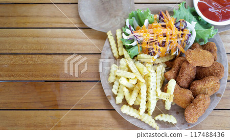 Home made chicken nugget served with french fries and tomato sauce, kids meal set presentation. 117488436