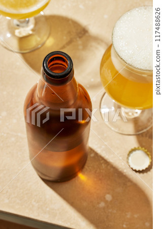 bottle and glasses of beer bottle and glasses of beer 117488626