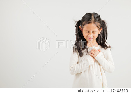 Young kid girl pressing on chest pain isolated on white background, painful expression heartache, kindergarten children having heart attack heart disease, Painful cramps problem 117488763