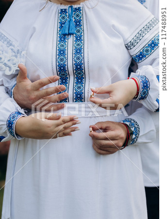 Beautiful close-up of a bride and groom exchanging wedding rings during a romantic ceremony Beautiful close-up of a bride and groom exchanging wedding rings during a romantic ceremony 117488951