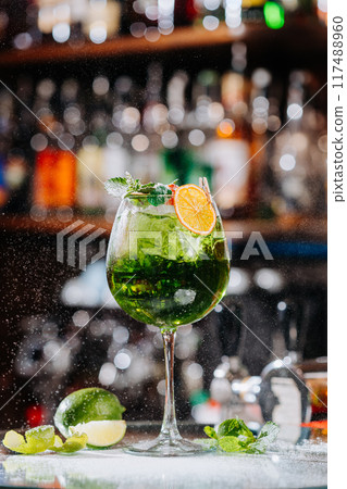 Refreshing green cocktail with lime and orange garnish, perfect for vibrant summer vibes Refreshing green cocktail with lime and orange garnish, perfect for vibrant summer vibes 117488960