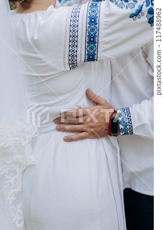 Ukrainian wedding embrace highlighting love and cultural heritage through embroidered attire Ukrainian wedding embrace highlighting love and cultural heritage through embroidered attire 117488962