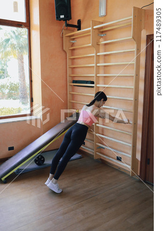 Woman Doing Push Up Exercise In The Gym 117489305