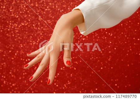 Womans hand with red minimalist nail design. Manicure, pedicure beauty salon concept Womans hand with red minimalist nail design. Manicure, pedicure beauty salon concept 117489770