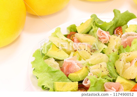 Pomelo, prosciutto and avocado salad on a light background Pomelo, prosciutto and avocado salad on a light background 117490052