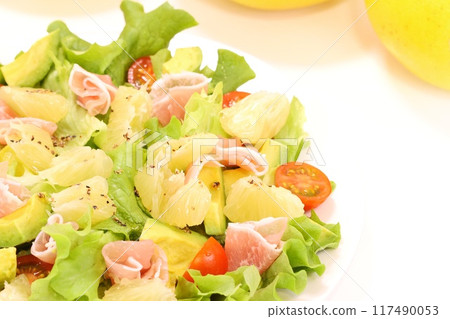 Pomelo, prosciutto and avocado salad on a light background Pomelo, prosciutto and avocado salad on a light background 117490053